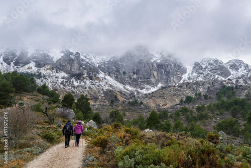Sierra de Aitana with snow. Couple hiking in Sierra de Aitana.The Sierra de Aitana is the highest point in the Province of Alicante with 1,557 meters of altitude. Located in Benifato, Alicante, Spain