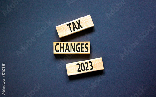 Tax changes 2023 symbol. Concept words Tax changes 2023 on wooden blocks on a beautiful black table black background. Business Tax changes 2023 concept. Copy space.