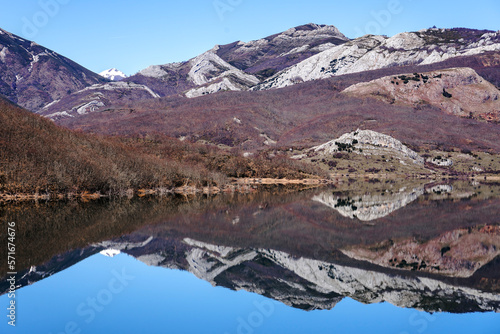 View since the Viewpoint of the porma reservoir, in the province of leon, on a sunny day with the Susarón peak and mountains reflected in the water of the reservoir. Castilla y Leon, Spain.