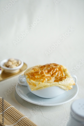 Grainy homemade creamy soup dish with corn potage and crisp puff pastry. Known as Zuppa Soup in Indonesia