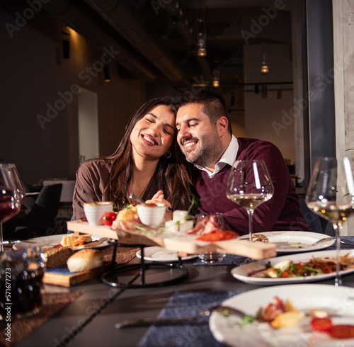Happy couple Laughing at Dinner Table