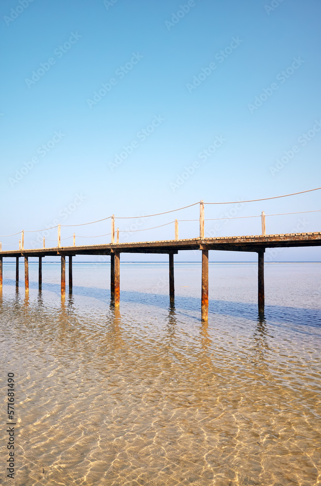 Wooden sea pier, summer vacation concept, color toning applied. Wooden sea pier, summer vacation concept, color toning applied.