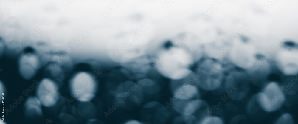 Atmospheric minimal monochrome backdrop with rain droplets on glass. Wet window with rainy drops and dirt spots closeup. Blurry minimalist background of dirty window glass with raindrops close up. Atmospheric minimal monochrome backdrop with rain droplets on glass. Wet window with rainy drops and dirt spots closeup. Blurry minimalist background of dirty window glass with raindrops close up.