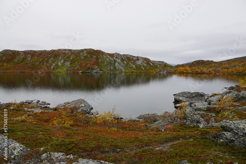 Lake in mountain area with rocks and autumn colors