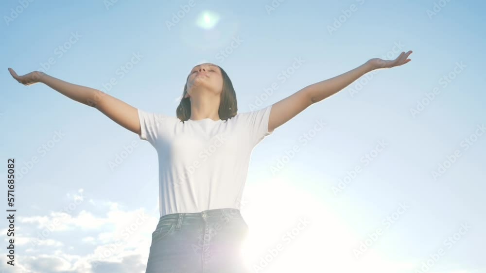 Happy celebration of victory success of young woman against background sky with her hands raised above her head. Achieve dream success. Delight young woman with happiness. Raising up his hands in sky Happy celebration of victory success of young woman against background sky with her hands raised above her head. Achieve dream success. Delight young woman with happiness. Raising up his hands in sky