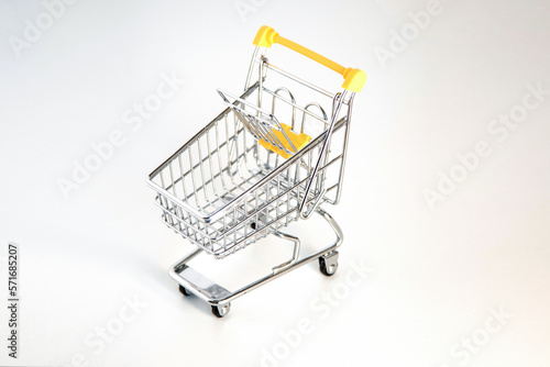 Empty supermarket shopping cart isolated on a white background. 
