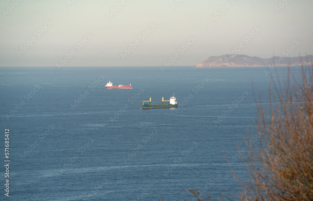 Two cargo ships in the blue sea Two cargo ships in the blue sea
