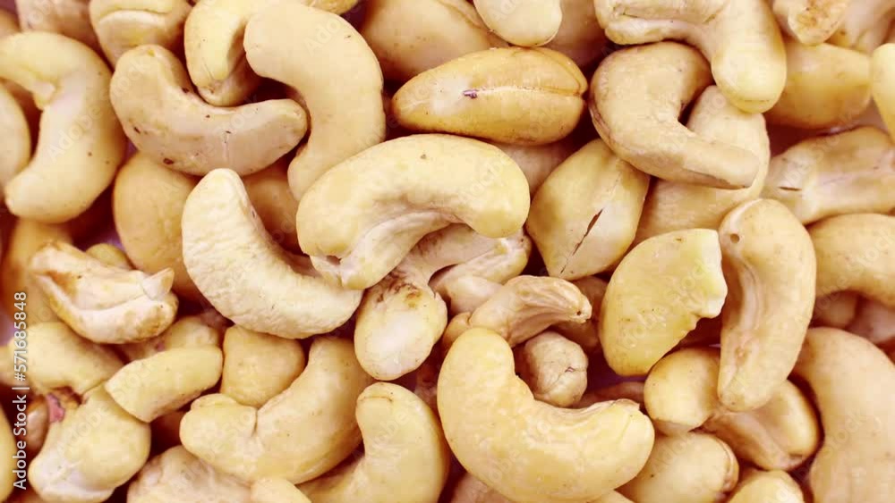 Top view of yellow peeled whole cashew nuts circle rotation close up Top view of yellow peeled whole cashew nuts circle rotation close up