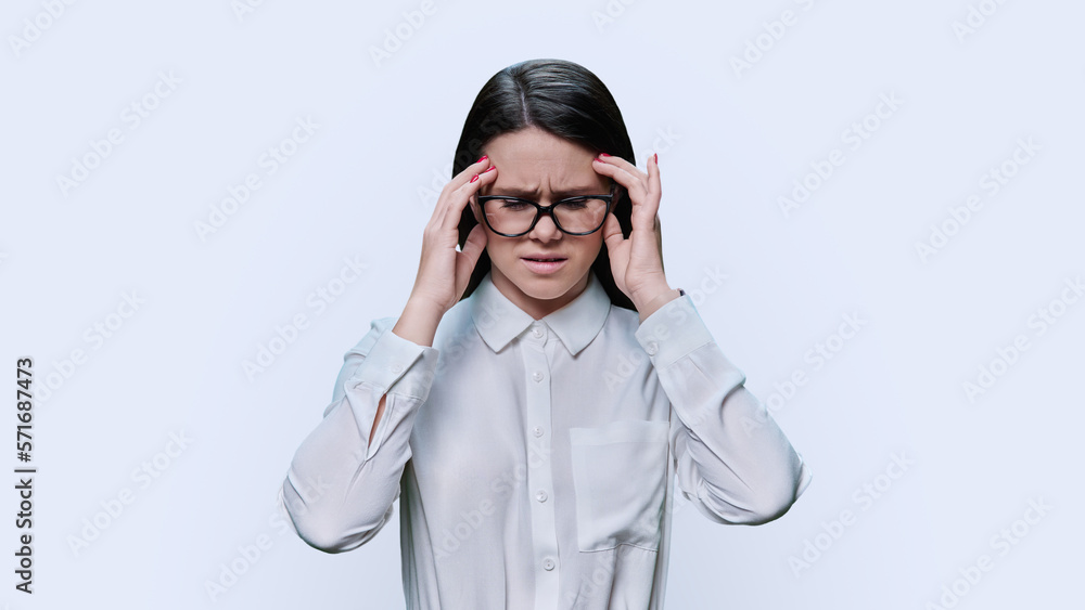 Young woman suffering from stress headache, over white background Young woman suffering from stress headache, over white background