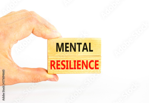 Mental resilience symbol. Concept word Mental resilience typed on wooden blocks. Beautiful white table white background. Doctor hand. Business psychological and mental resilience concept. Copy space.