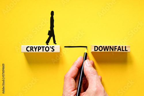 Crypto downfall symbol. Concept words Cryptos downfall on wooden blocks. Beautiful yellow table yellow background. Businessman hand. Business and crypto downfall concept. Copy space.