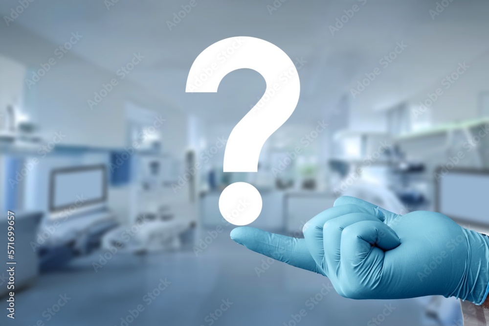 Hand of doctor holding a big question mark Hand of doctor holding a big question mark