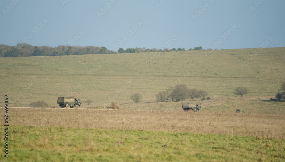 British army MAN SV 4x4 green logistics lorries in action in countryside