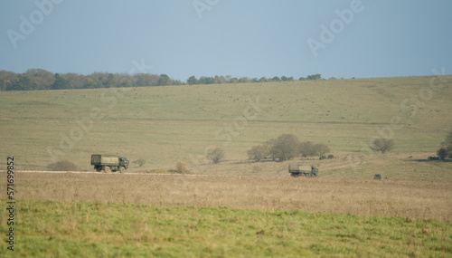 British army MAN SV 4x4 green logistics lorries in action in countryside © Martin
