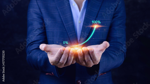 Businessman showing a growing virtual hologram stock, invest in trading. planning and strategyto that has grown exponentially rapidly from 0 percent to 100 percent sales.