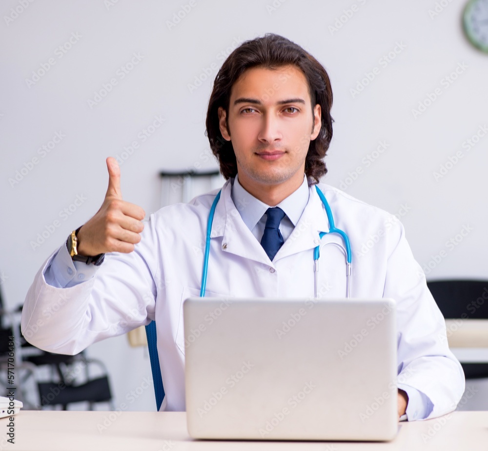 Young handsome doctor in telemedicine concept Young handsome doctor in telemedicine concept