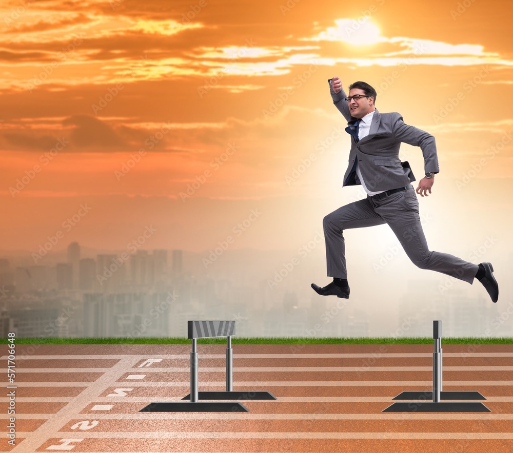 Businessman jumping over barriers in business concept Businessman jumping over barriers in business concept