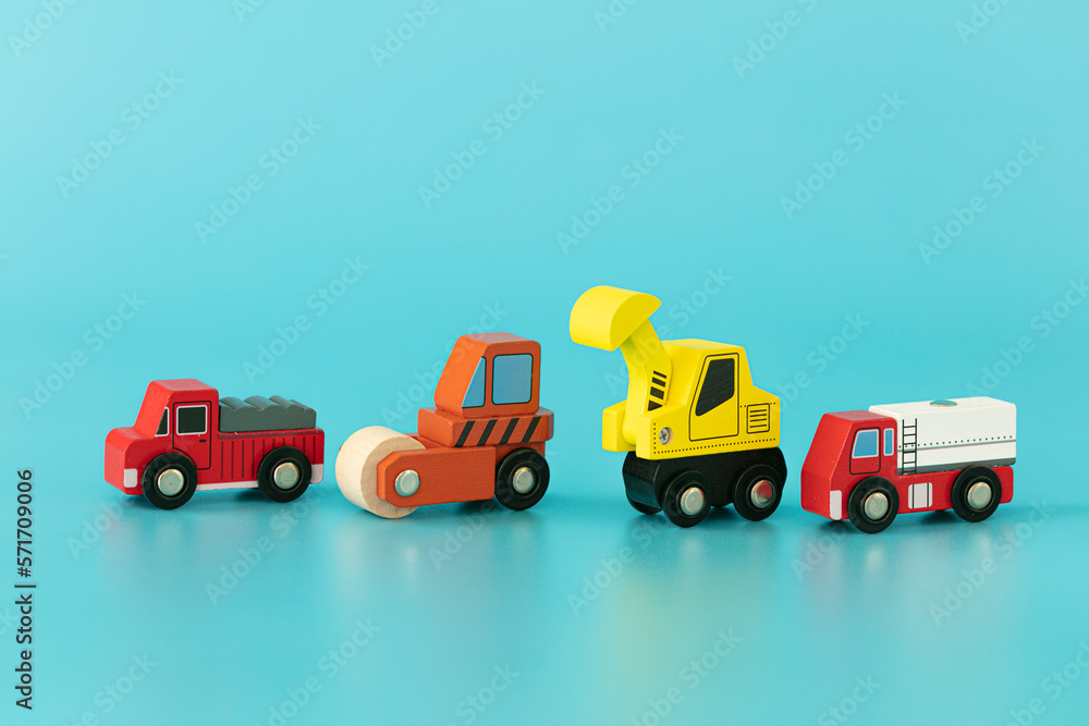 Wood sings: construction trucks on blue background isolated. Symbols: wood toys for kids. Wood sings: construction trucks on blue background isolated. Symbols: wood toys for kids.