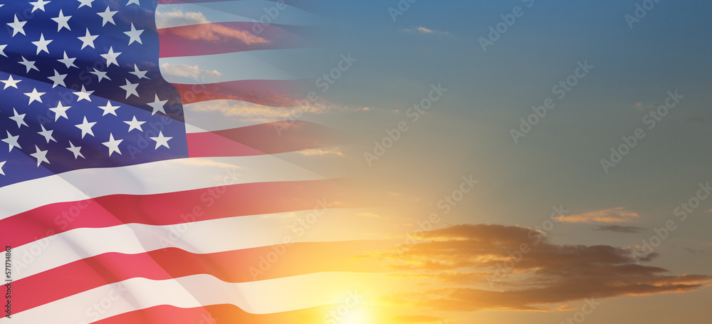 Fototapeta premium United States of America flag on sky at sunset or sunrise background. Independence day, Memorial day, Veterans day. Banner.