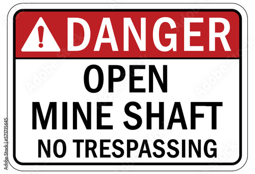 Active mine site warning sign and labels open shaft no trespassing