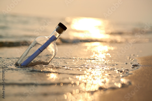 Bottle with a message on sea or ocean beach. Hope concept