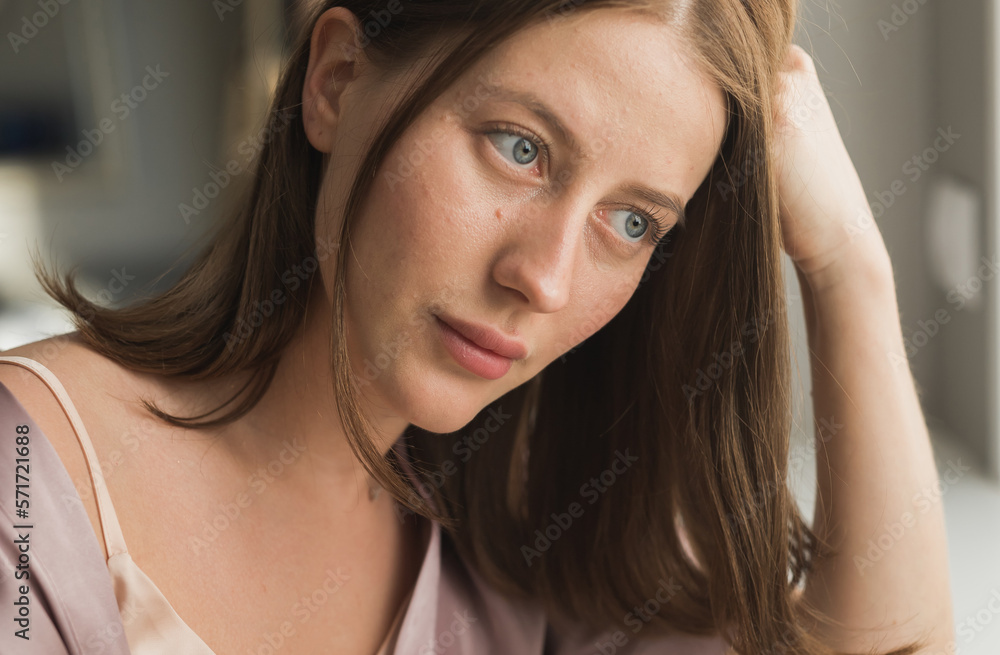 Depressed young woman near window at home portrait, closeup. Depressed young woman near window at home portrait, closeup.