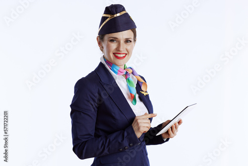 smiling stylish female stewardess on white