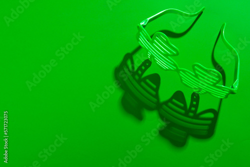 Image of green clover glasses and copy space on green background