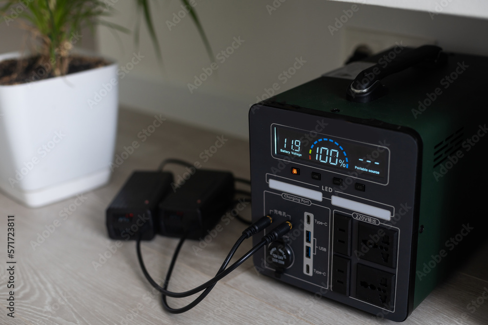 Fototapeta premium Charging station for gadgets when there is no light during blackout. Generator power bank battery in the absence of electricity. Charge electric rechargeable battery