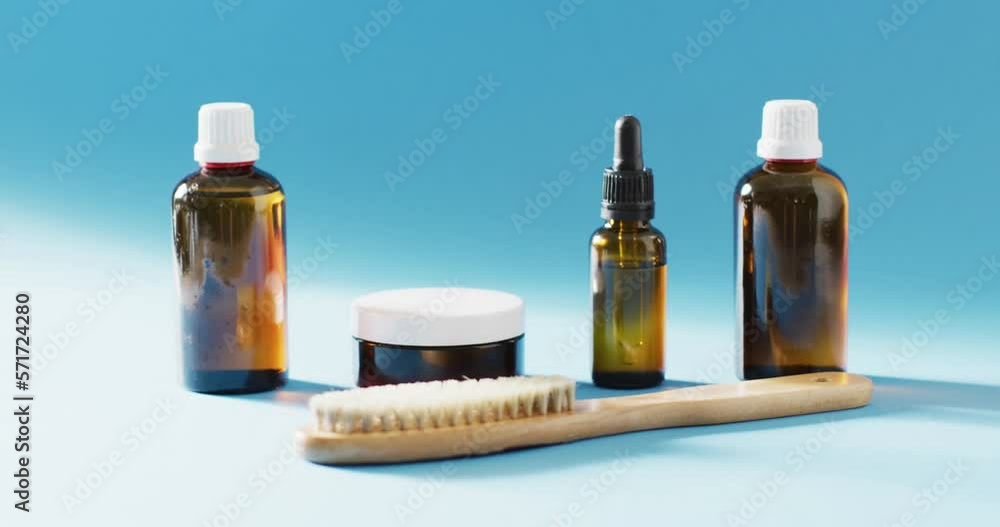 Close up of different beauty products on blue background with copy space Close up of different beauty products on blue background with copy space