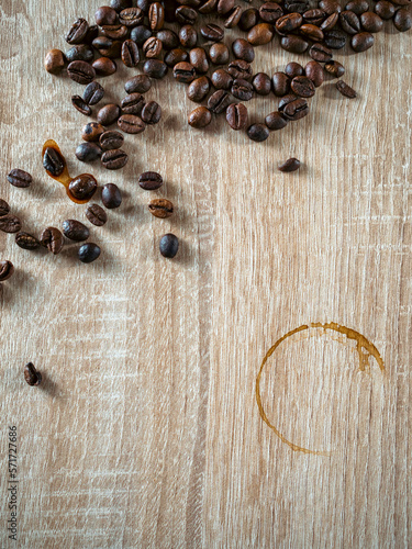 Ring of dry brown coffee cup isolated on wooden table, top view