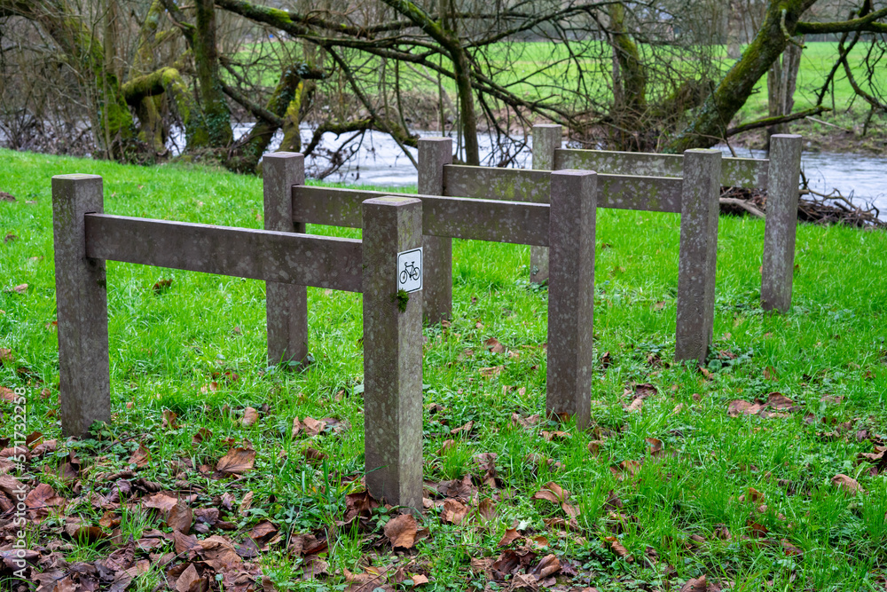 Parking lot for bicycles on green grass. Facilities for public bicycle parking for hikers and hikers near the river. Parking lot for bicycles on green grass. Facilities for public bicycle parking for hikers and hikers near the river.