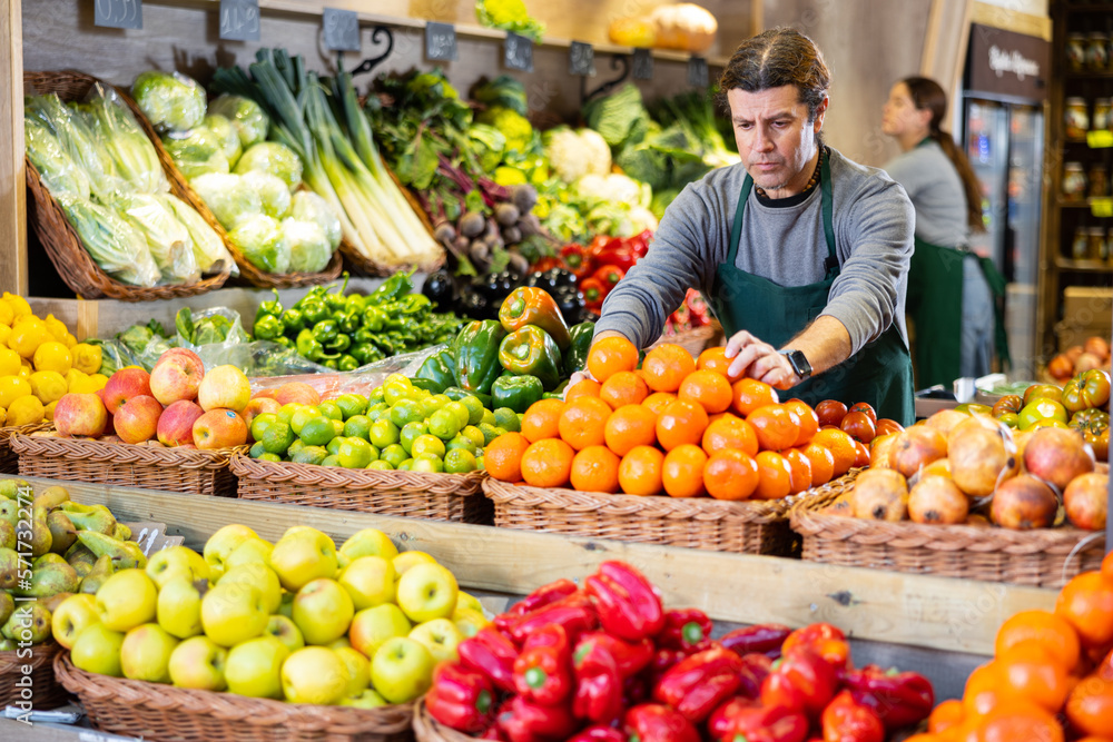 Supermarket employee will lay out ripe fruits and vegetables on the counter