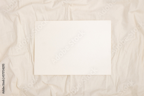 Blank note paper on a fabric background.