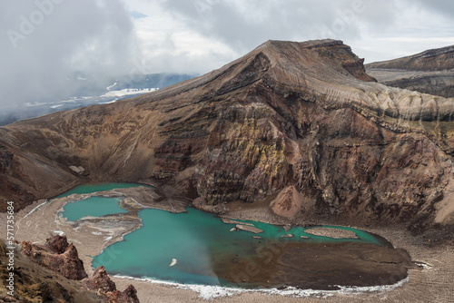 View of the volcano crater. Majestic mountain landscape. Lake in a volcanic crater. Travel, tourism and hiking on the Kamchatka Peninsula. Nature of the Far East of Russia. Gorely volcano, Kamchatka.