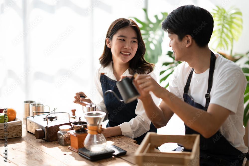 Young smiling couple in love spending a weekend morning together while making coffee at the kitchen, having breakfast together. Young smiling couple in love spending a weekend morning together while making coffee at the kitchen, having breakfast together.