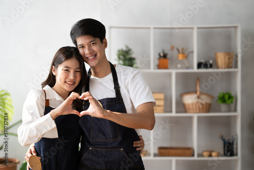 Happy mature couple having their quality time together in the kitchen, preparing cooking food meal for romantic dinner, spending time together.