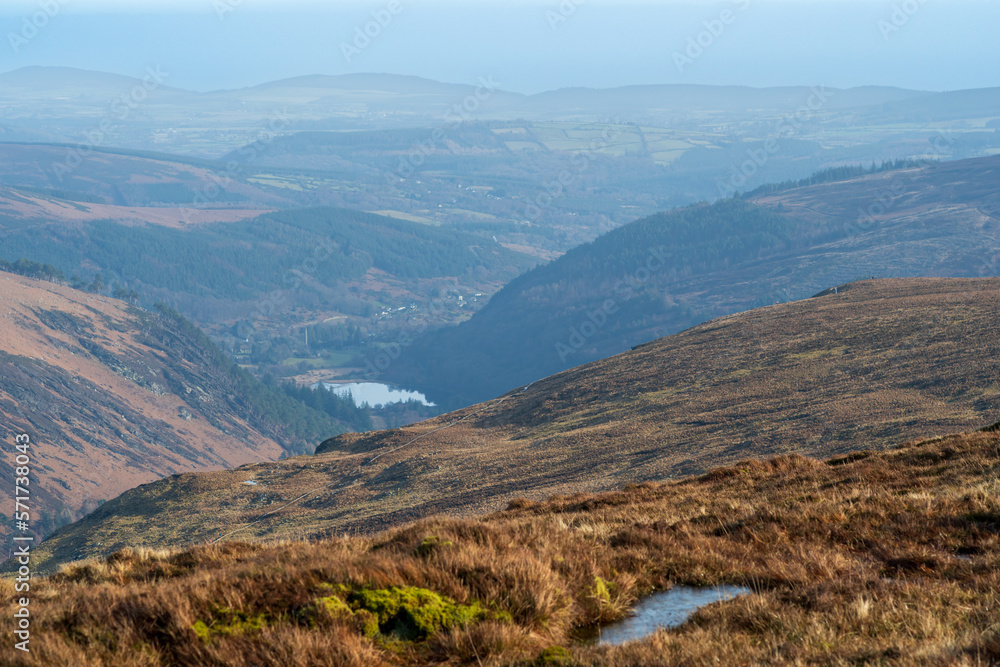 Panoramic view of Glendalough valley from Lugduff mountain during sunny summer in Ireland