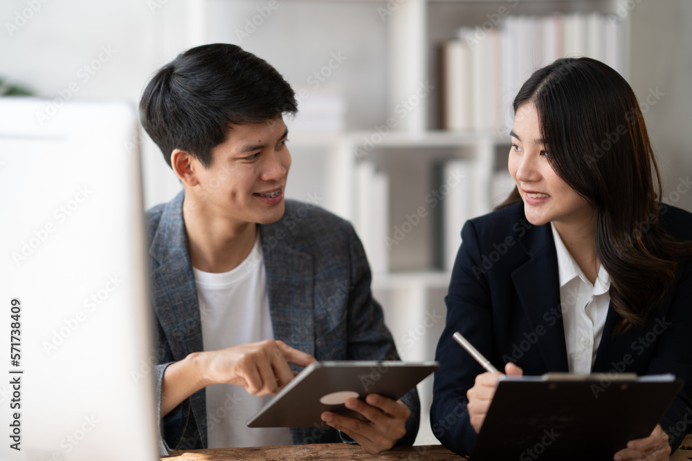 Young charming Asian businesswoman working and discussing together in the modern office room. Young charming Asian businesswoman working and discussing together in the modern office room.
