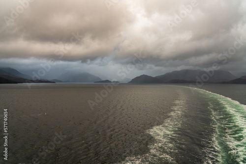 Rain over the mountains as cruise ship sails through the fjords of Chile and Patagonia