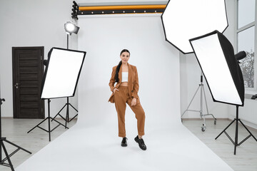 Beautiful young model posing in modern studio. Professional photo session