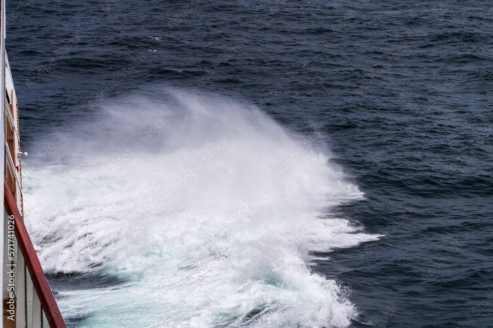 Fototapeta premium Bow of cruise ship in heavy seas and swell with waves crashing from the front of boat