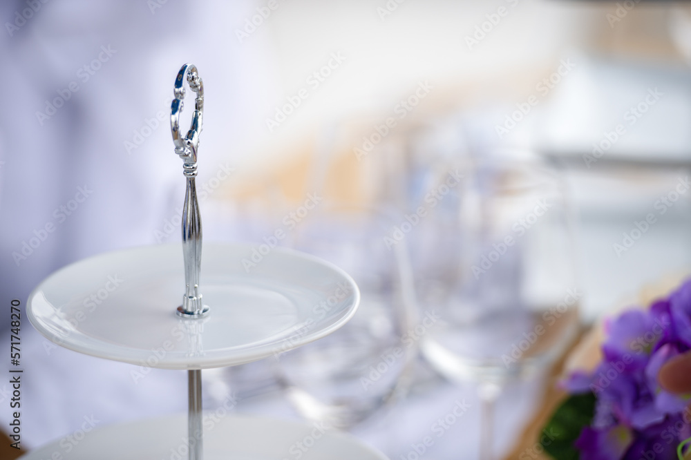 Bartender waiter use white cloth wipe wine glass for afternoon tea decorate catering banquet table services on bartender counter in hotel restaurant. Snack foods serving in party event.