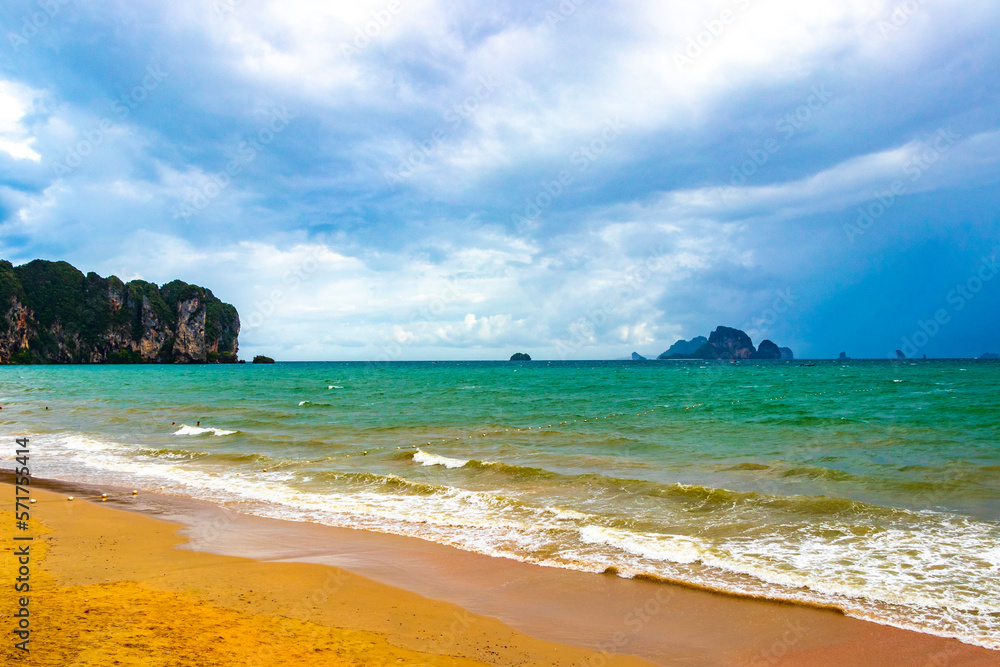 Tropical paradise turquoise water beach and  limestone rocks Krabi Thailand.