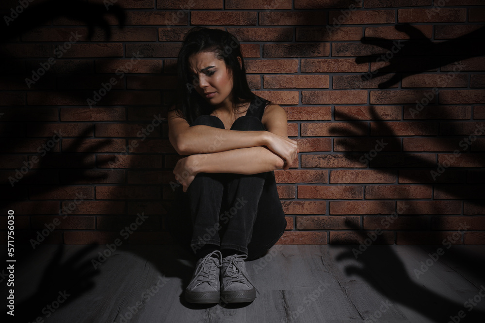 Paranoid Individual Scared Woman Sitting Near Brick Wall And Having Delusion As Hands Reaching