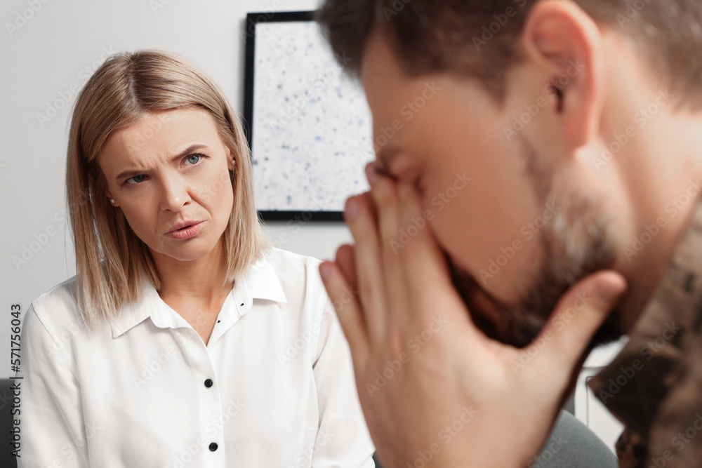 Psychologist working with military officer in office Psychologist working with military officer in office