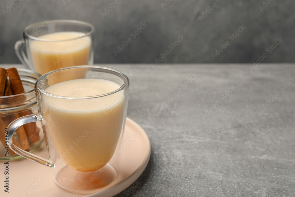 Delicious eggnog with cinnamon on light grey table. Space for text Delicious eggnog with cinnamon on light grey table. Space for text