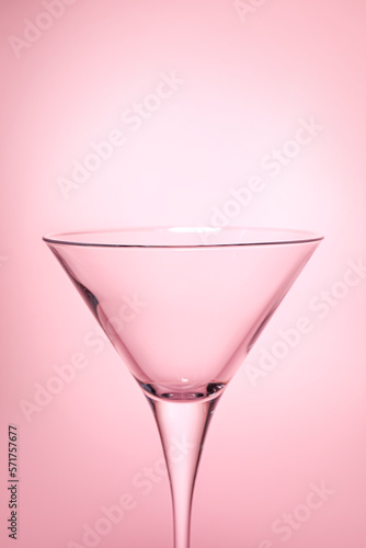 Elegant empty martini glass on pink background, closeup. Space for text