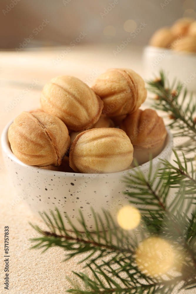 Delicious nut shaped cookies and fir tree branch on table, closeup Delicious nut shaped cookies and fir tree branch on table, closeup