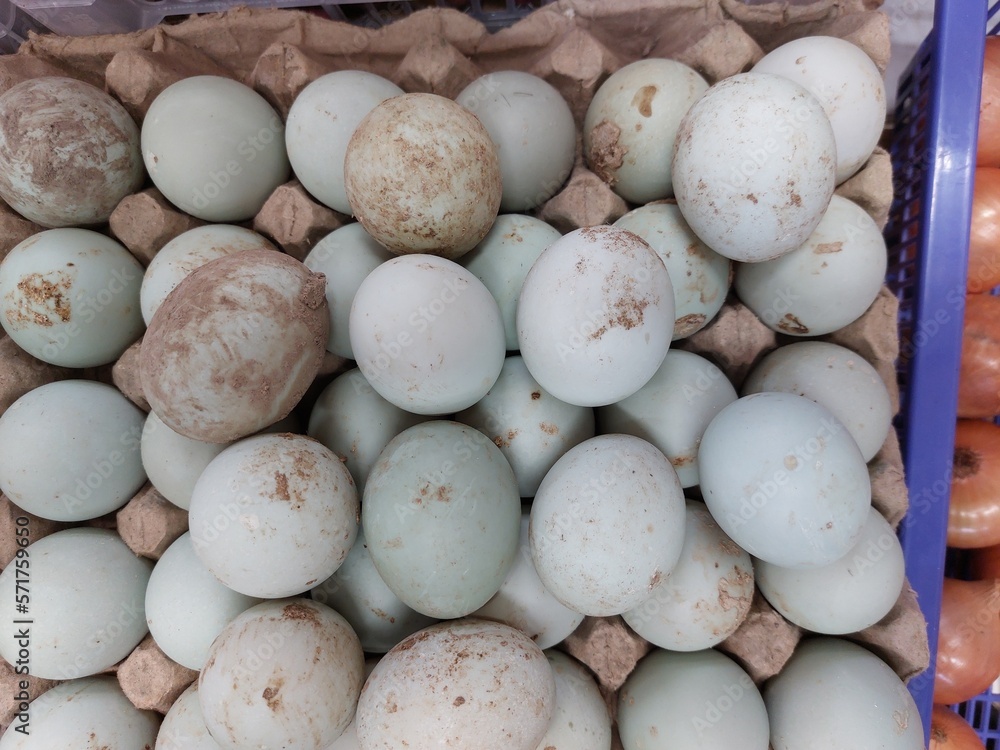 Duck fresh eggs pile for sale at a market as background Duck fresh eggs pile for sale at a market as background